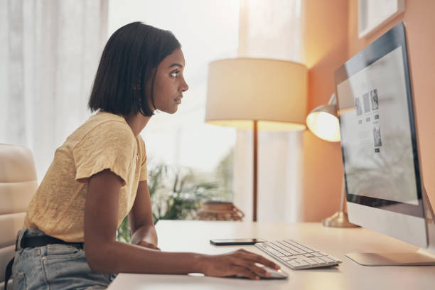 Image of a young woman using a computer while working from home